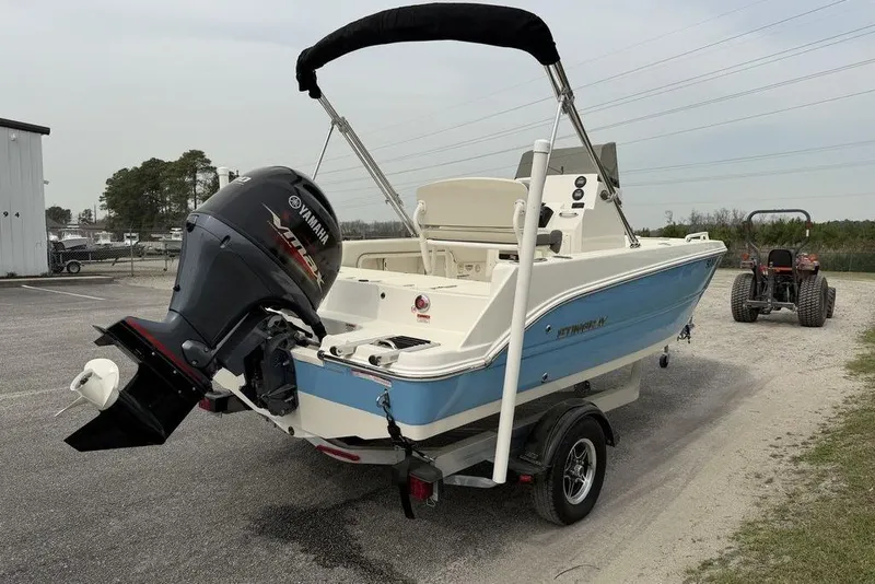 Slide: The Image of 2004 Robalo R260 Center Console boat dashboard with steering wheel and navigation instruments. - 10