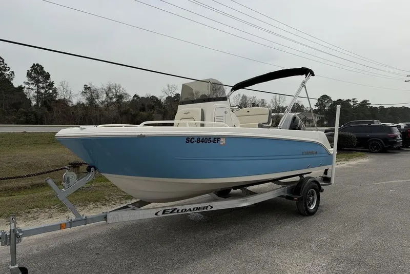 Slide: The Image of 2004 Robalo R260 Center Console boat on trailer, side view. - 2