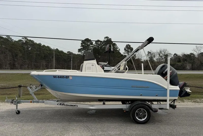 Slide: The Image of 2004 Robalo R260 Center Console boat with Yamaha outboard engines, parked on gravel. - 4