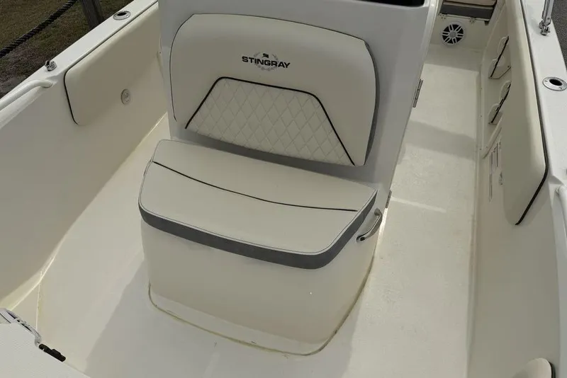 Slide: The Image of 2004 Robalo R260 Center Console boat interior with dual seats and fishing rod holders. - 8