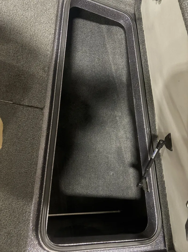 Slide: The Image of Open storage compartment in 2011 Ranger 620 VS boat. - 24