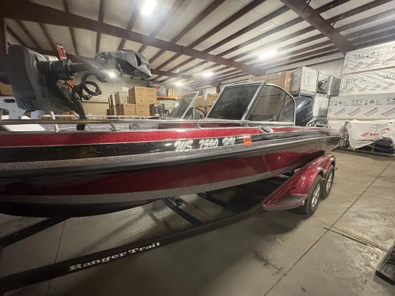 Slide: The Image of 2011 Ranger 620 VS boat in warehouse, red and black, on trailer. - 6