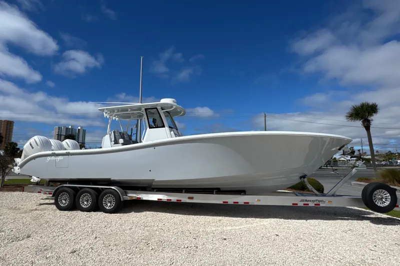 The Image of 2026 Yellowfin 36 Offshore boat on trailer under blue sky. - 1