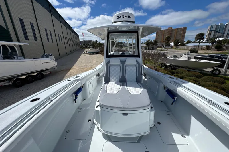 Slide: The Image of 2026 Yellowfin 36 Offshore boat with Garmin equipment, docked outdoors under a blue sky. - 12