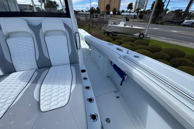 Slide: The Image of 2026 Yellowfin 36 Offshore boat interior with cushioned seating and rod holders. - 15