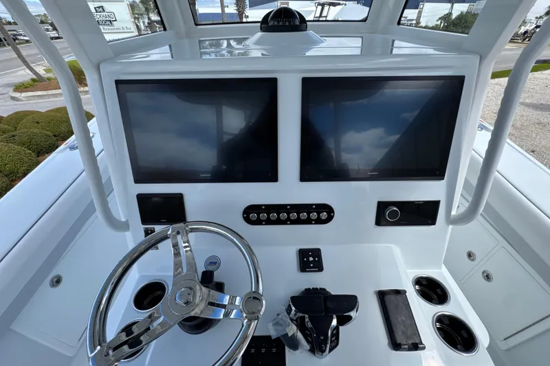 Slide: The Image of 2026 Yellowfin 36 Offshore boat dashboard with dual screens and steering wheel. - 19