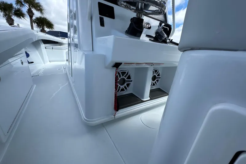 Slide: The Image of 2026 Yellowfin 36 Offshore boat interior with steering console and speakers. - 20