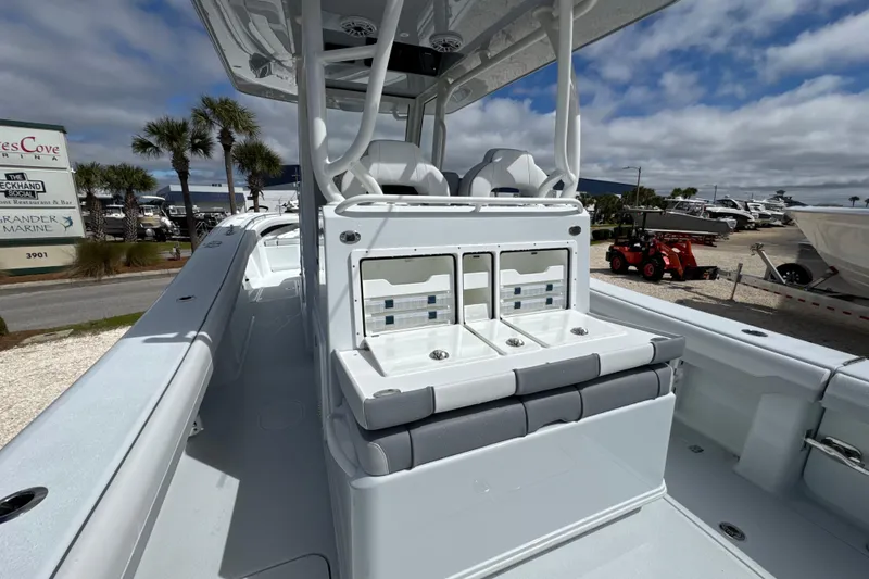 Slide: The Image of 2026 Yellowfin 36 Offshore boat interior with seating and storage, under a partly cloudy sky. - 22