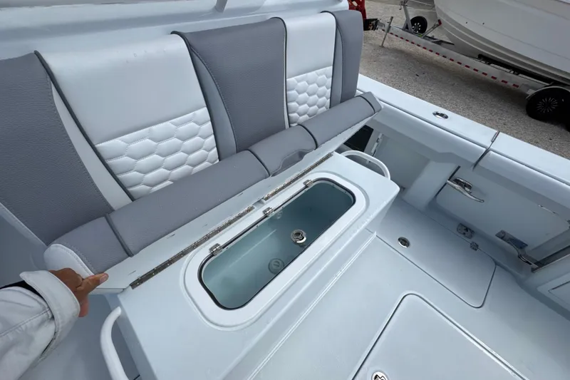 Slide: The Image of 2026 Yellowfin 36 Offshore boat interior with cushioned seating and storage compartment. - 23