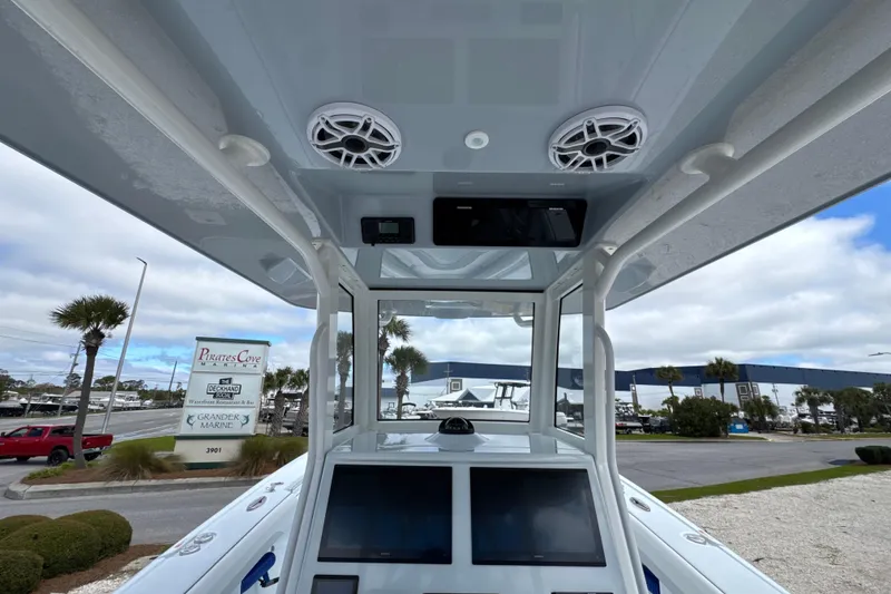 Slide: The Image of 2026 Yellowfin 36 Offshore boat interior with electronics and speakers at marina. - 27