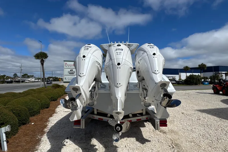 Slide: The Image of 2026 Yellowfin 36 Offshore boat with triple 350 V8 outboard engines, parked outdoors. - 4