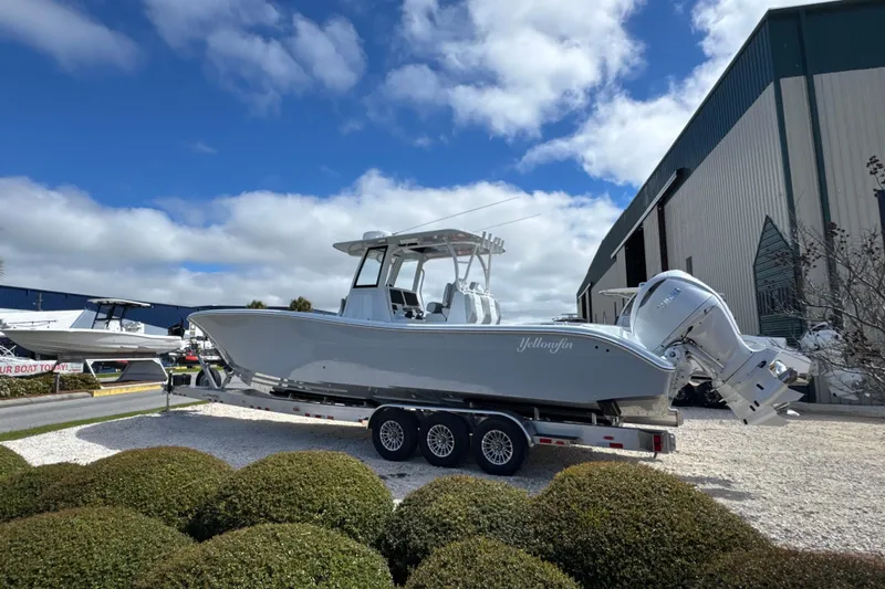 Slide: The Image of 2026 Yellowfin 36 Offshore boat on trailer, parked outdoors under blue sky. - 5