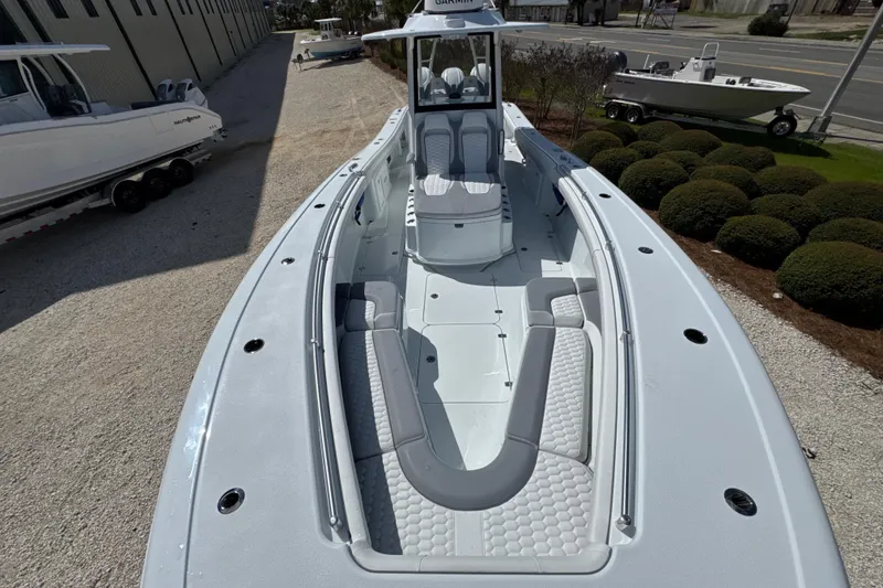 Slide: The Image of 2026 Yellowfin 36 Offshore boat with spacious deck and seating, parked outdoors. - 9