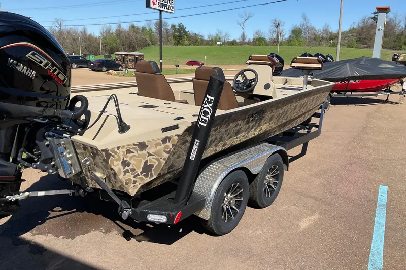 Slide: The Image of 2026 Excel EX 203 boat on trailer with Yamaha engine, parked outdoors. - 2