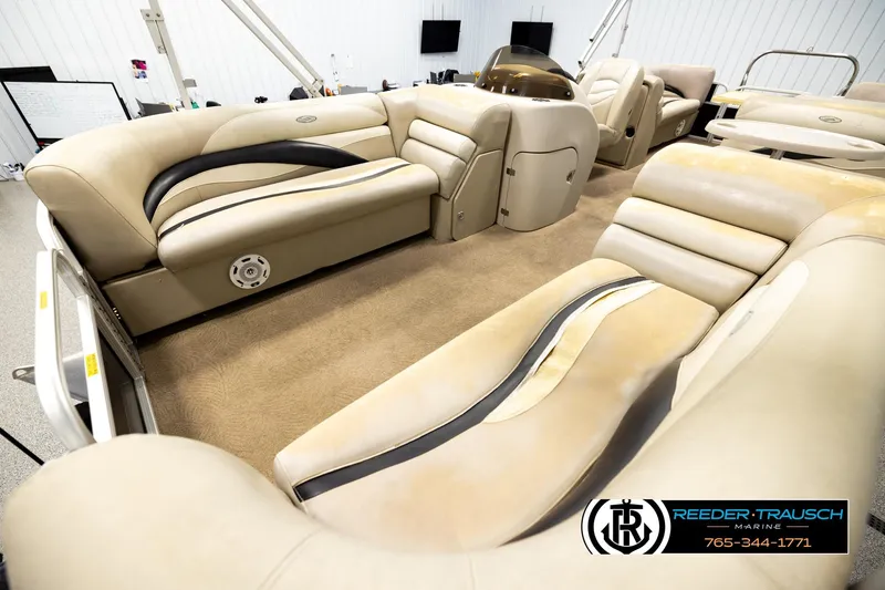 Slide: The Image of Interior of a 2011 Godfrey SW2486 pontoon boat with beige seating and carpet. - 10