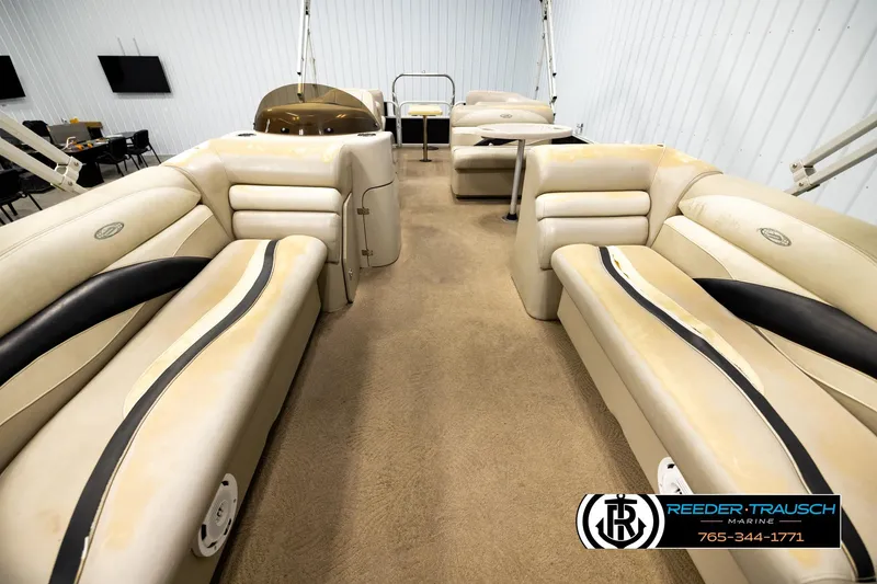 Slide: The Image of Interior of a 2011 Godfrey SW2486 boat with beige seating and carpet flooring. - 13