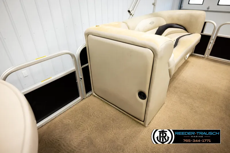 Slide: The Image of 2011 Godfrey SW2486 boat interior with beige seating and carpet flooring. - 20