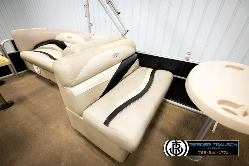 Slide: The Image of Luxurious seating on a 2011 Godfrey SW2486 boat, featuring beige upholstery and sleek design. - 23