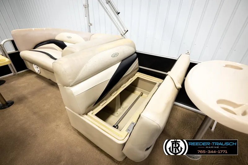 Slide: The Image of 2011 Godfrey SW2486 boat interior with beige seating and storage compartment. - 24