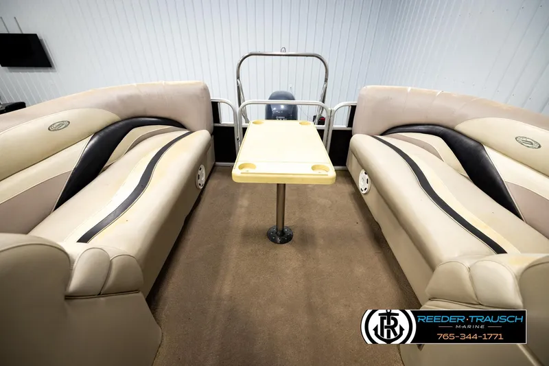 Slide: The Image of Interior of 2011 Godfrey SW2486 boat with beige seating and central table. - 25