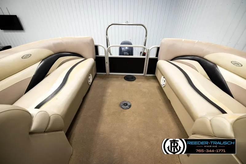 Slide: The Image of Interior of a 2011 Godfrey SW2486 boat with beige seating and carpeted floor. - 26