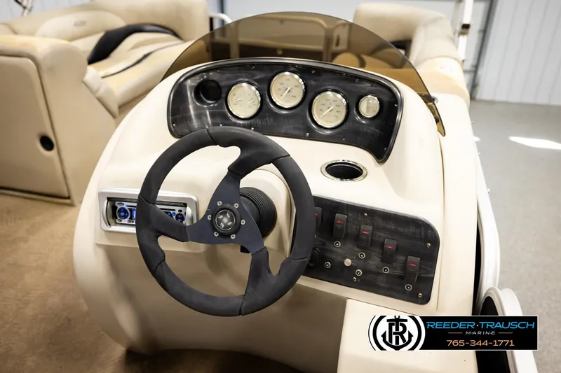 Slide: The Image of Steering console of 2011 Godfrey SW2486 boat with gauges and controls. - 28