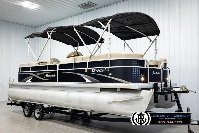 Slide: The Image of 2011 Godfrey Sweetwater SW2486 pontoon boat with canopy on trailer in indoor showroom. - 3