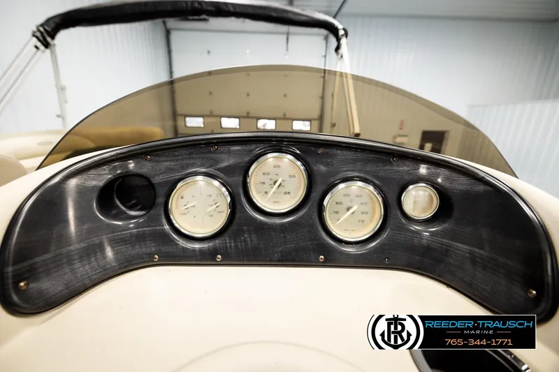 Slide: The Image of Dashboard of 2011 Godfrey SW2486 boat with gauges, Reeder-Trausch Marine logo visible. - 32