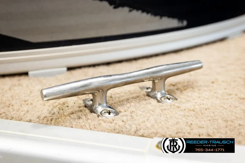 Slide: The Image of Stainless steel boat cleat on carpeted deck, Godfrey sw2486, 2011 model. - 47