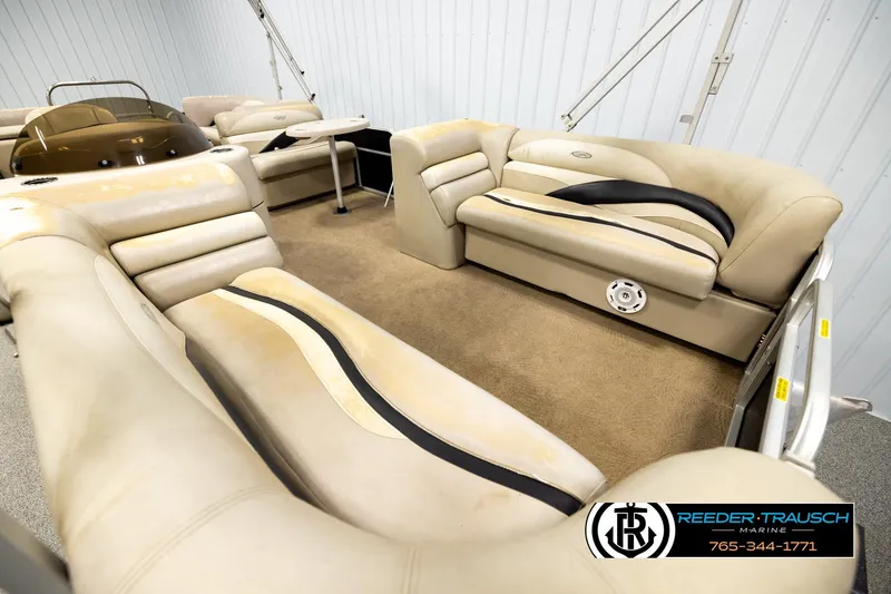 Slide: The Image of Interior of a 2011 Godfrey SW2486 boat with beige seating and carpet. - 9
