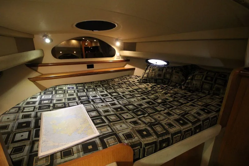 Slide: The Image of 2004 Cruisers Yachts 320 Express interior with cozy dining area and elegant wood finishes. - 15