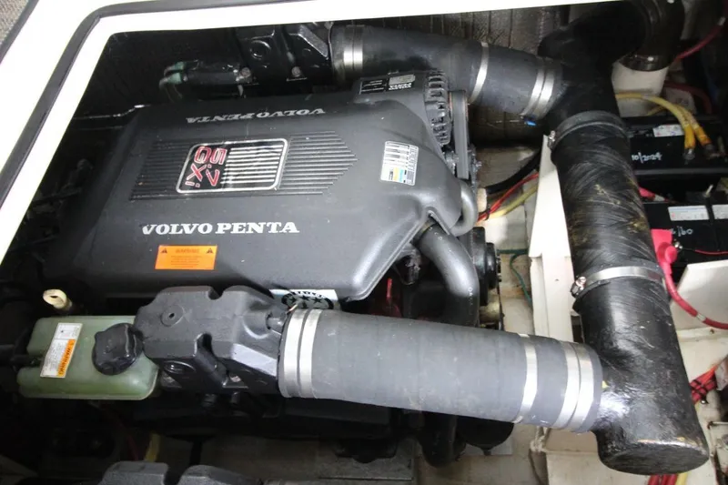 Slide: The Image of Cozy cabin interior of 2004 Cruisers Yachts 320 Express with patterned bedding and map. - 18