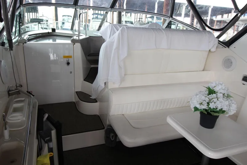 Slide: The Image of 2004 Cruisers Yachts 320 Express docked, featuring sleek design and spacious deck. - 4