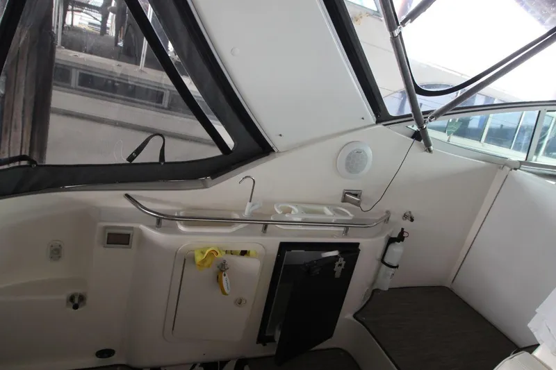 Slide: The Image of 2004 Cruisers Yachts 320 Express docked in a marina, featuring sleek design and spacious cabin. - 6