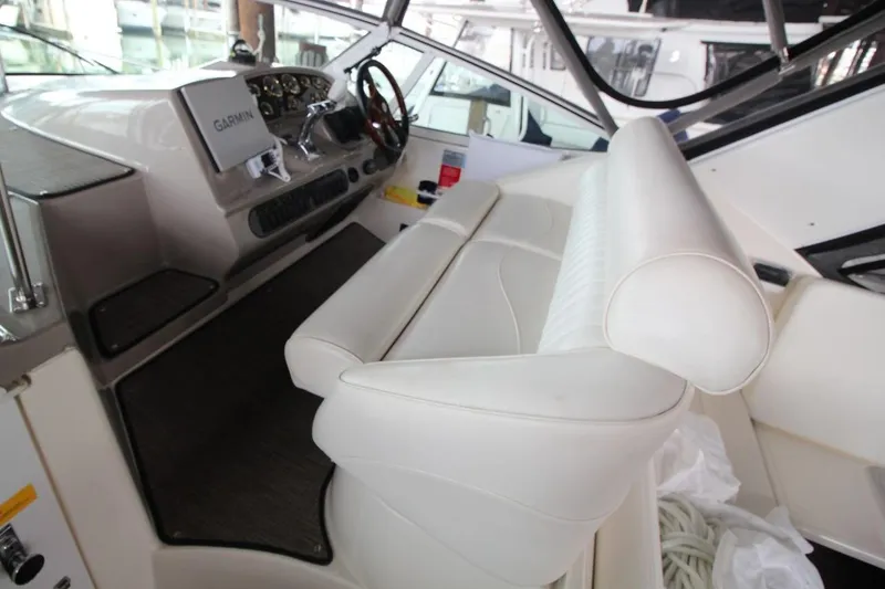 Slide: The Image of 2004 Cruisers Yachts 320 Express interior with white seating and floral decor. - 7