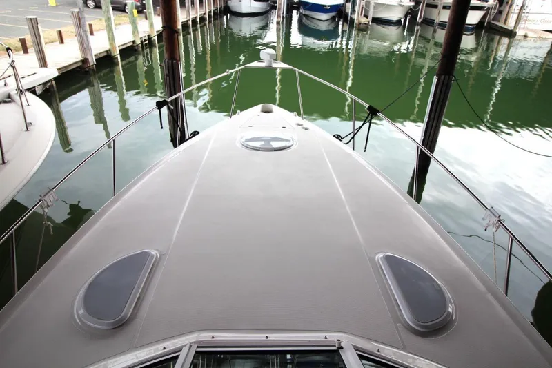 Slide: The Image of 2004 Cruisers Yachts 320 Express interior with kitchenette and seating area. - 9