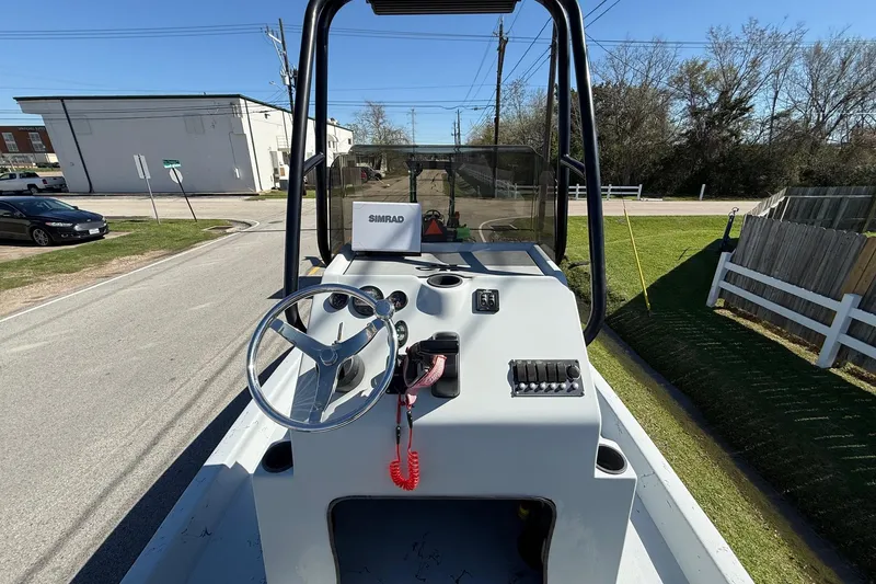 Slide: The Image of JH Performance boat console with steering wheel and Simrad display on a sunny day. - 10