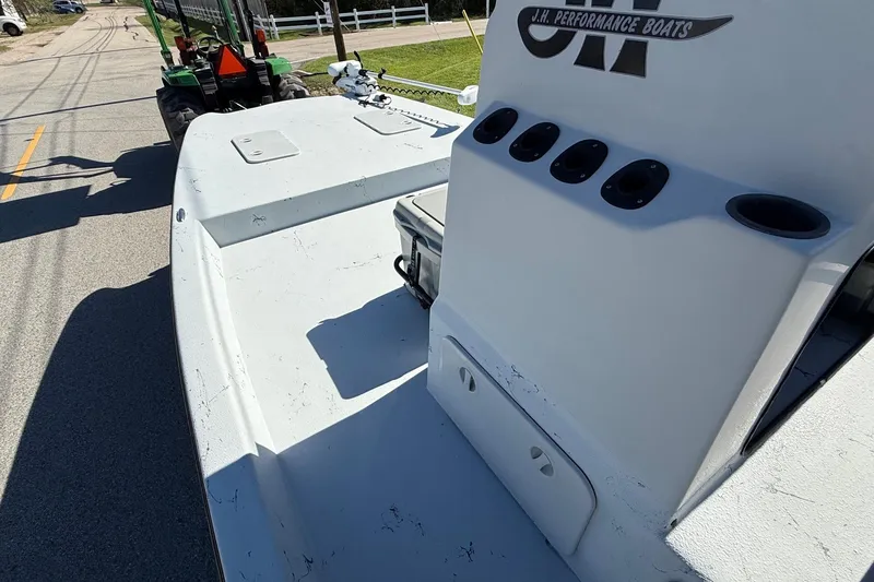 Slide: The Image of JH Performance boat console with rod holders on a trailer, sunny day. - 11