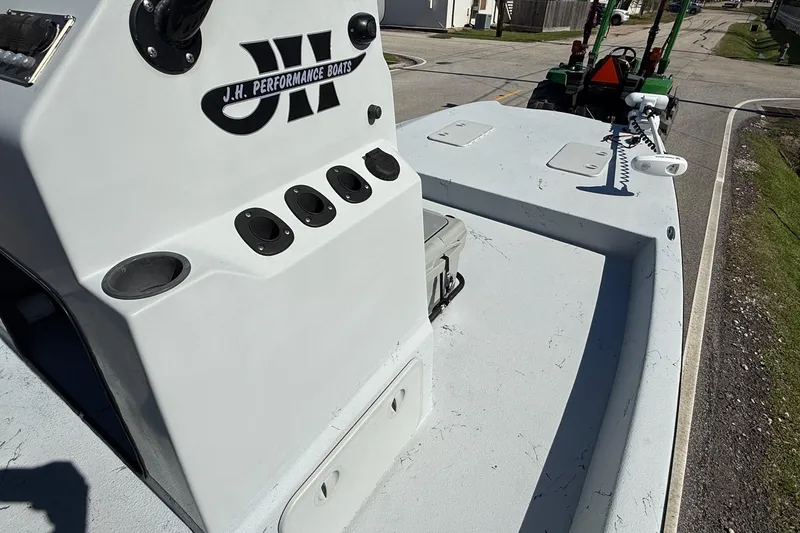 Slide: The Image of JH Performance boat console with rod holders and storage compartments on a trailer. - 13