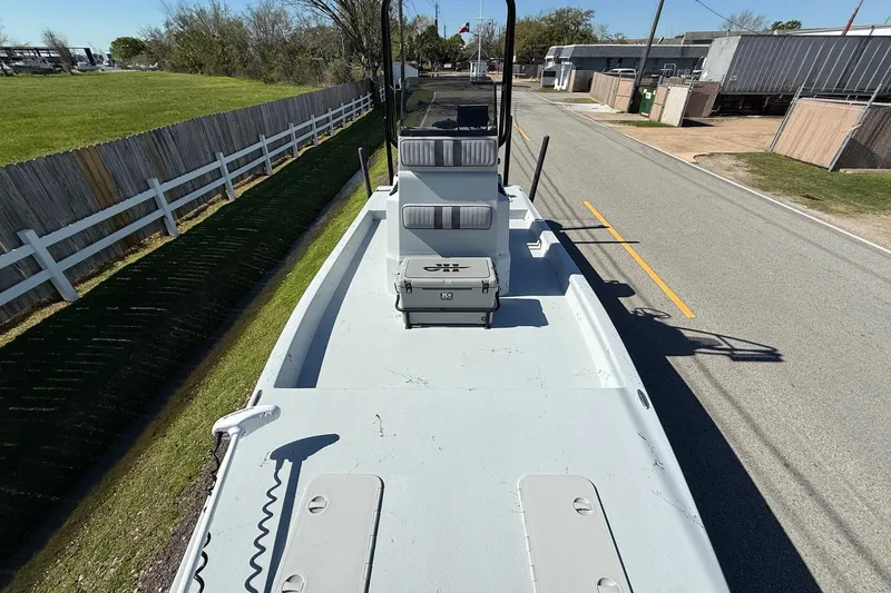 Slide: The Image of JH Performance boat on trailer, parked on roadside, with green grass and wooden fence. - 14