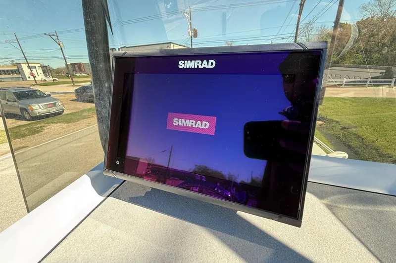 Slide: The Image of Simrad display screen on a JH Performance boat, reflecting outdoor scenery. - 15