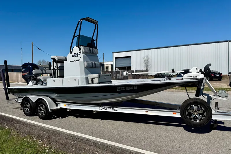 Slide: The Image of JH Performance boat on trailer, parked outdoors, clear sky background. - 5