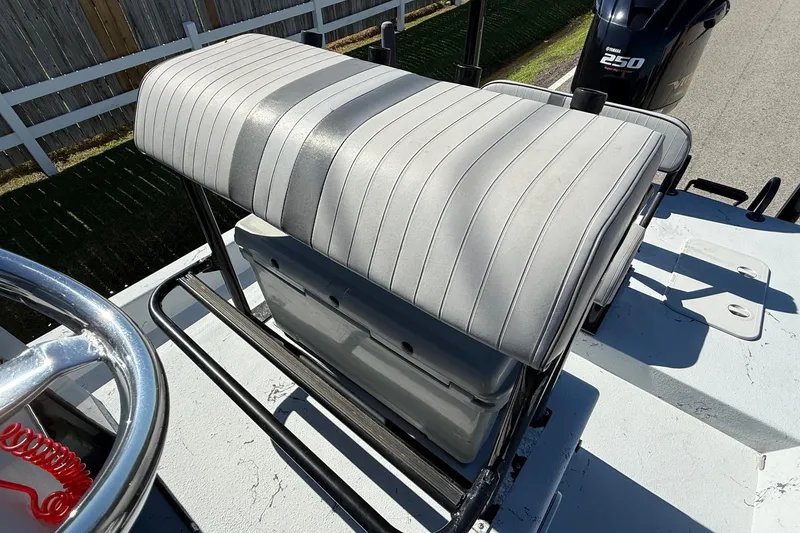 Slide: The Image of JH Performance boat seat with striped upholstery and Yamaha 250 engine in background. - 9