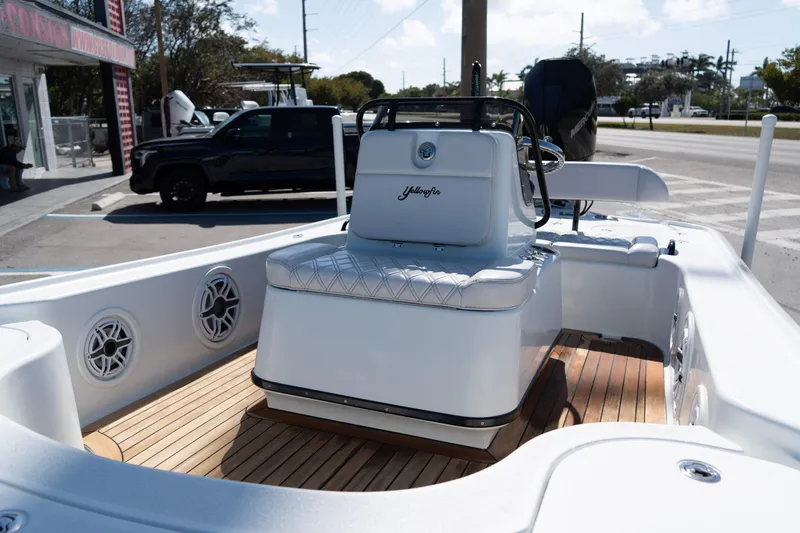 Slide: The Image of 2020 Yellowfin 21 Hybrid boat interior with seating and wood flooring. - 4