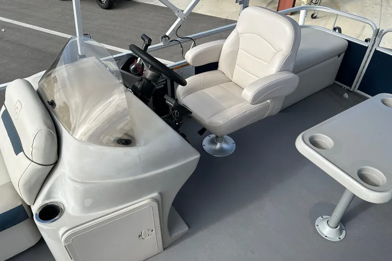 Slide: The Image of 2020 Godfrey SR 206 C boat interior with steering console and seating area. - 11