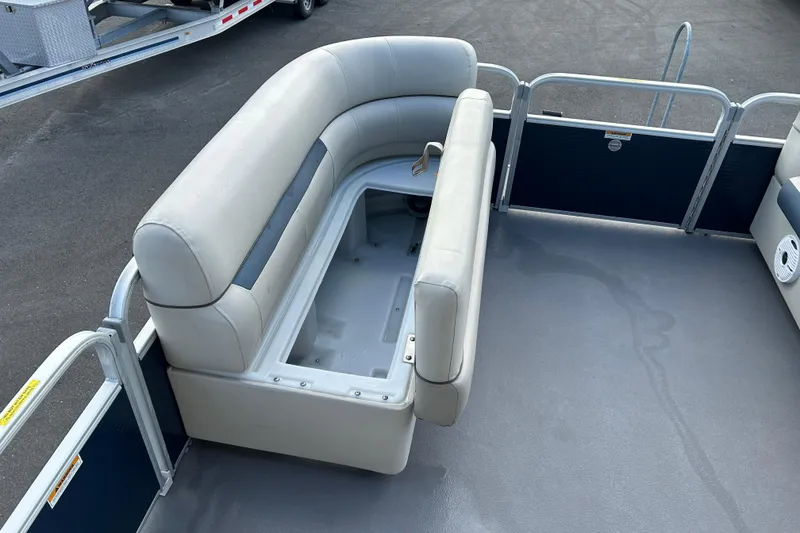 Slide: The Image of 2020 Godfrey SR 206 C pontoon boat with open storage compartment and cushioned seating. - 13