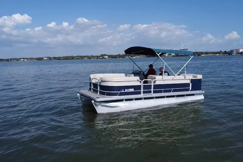 Slide: The Image of 2020 Godfrey SR 206 C pontoon boat cruising on a sunny lake. - 18