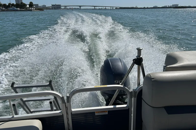 Slide: The Image of 2020 Godfrey SR 206 C boat cruising on open water, leaving a wake behind. - 20
