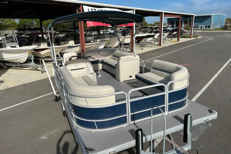Slide: The Image of 2020 Godfrey SR 206 C pontoon boat with spacious seating at a marina. - 6