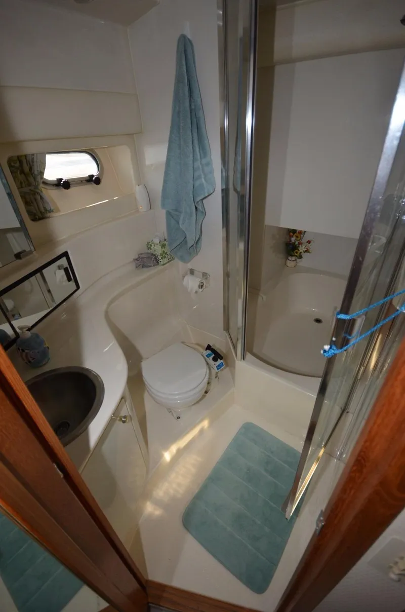 Slide: The Image of 1998 Bayliner 3988 yacht bathroom with shower and toilet. - 11